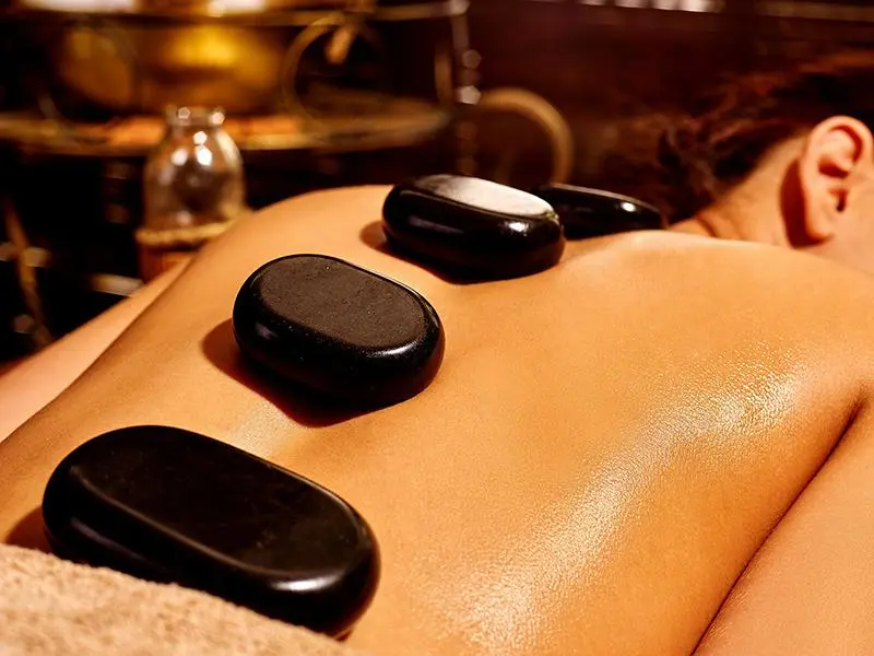 Guest enjoying herbal compress massage at Sapa spa retreat
